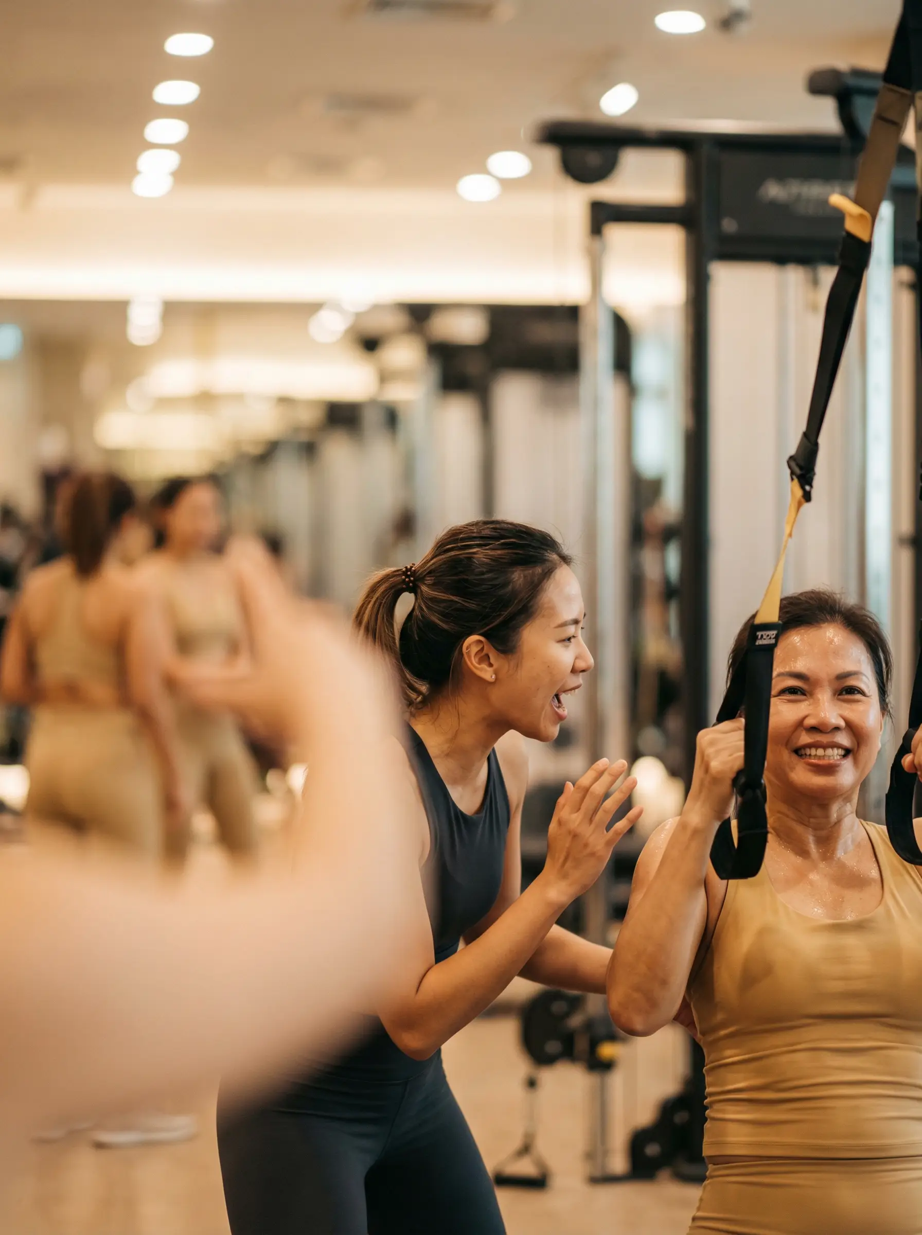 Female Contours Express coach encouraging a woman during her workout